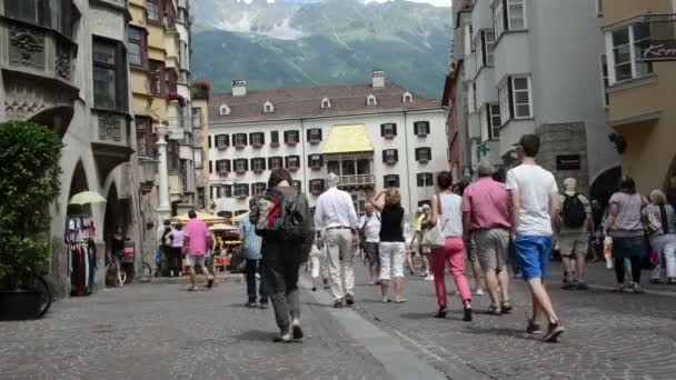 Gente caminando por Innsbruck con su techo dorado . — Vídeo de stock