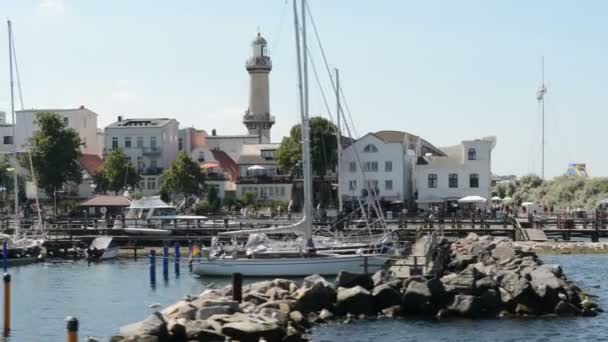 The marina of Warnemuende and parts of the old town with the light house and tea pot as well as the Neptune hotel. Located at Warnemuende — Stock Video