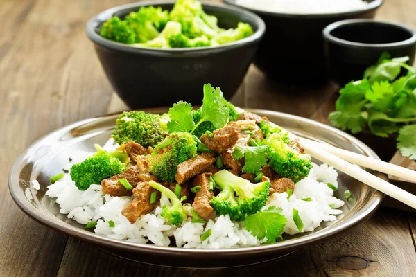 Beef with broccoli and rice. Asian cuisine.