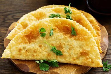 Chebureks etli, bir ahşap tahta