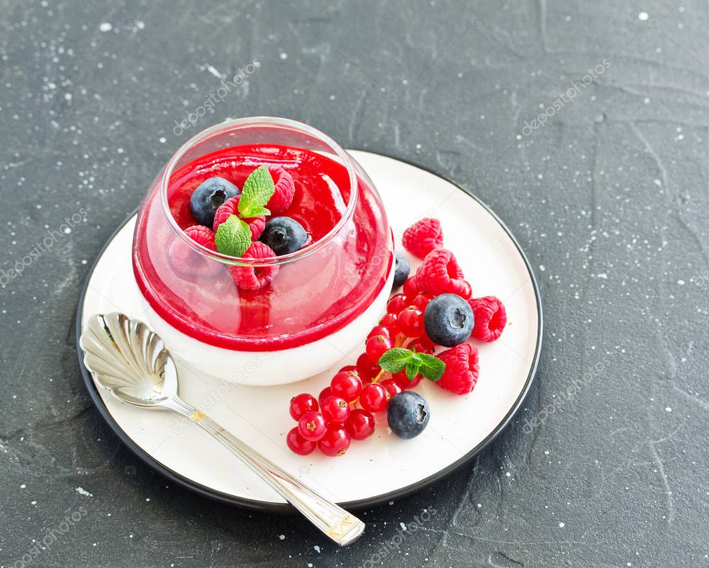 Delicious Italian dessert panna cotta with berries and berry sauce. Valentine's Day.