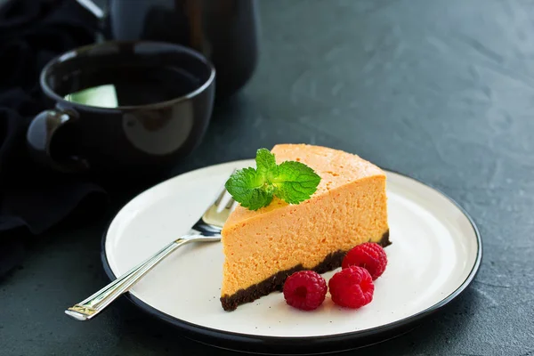 Pumpkin cheesecake with raspberries. Selective focus.
