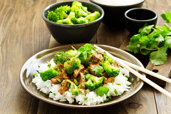 Beef with broccoli and rice. Asian cuisine.