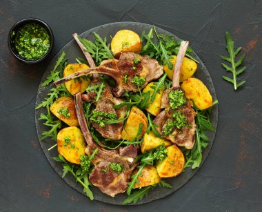 Pirzola kuzu kemik, fırında patates ve pesto sos ile.