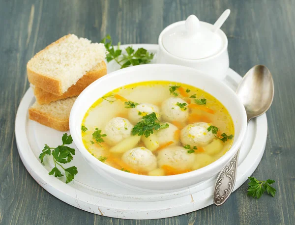 Homemade soup with chicken meatballs.