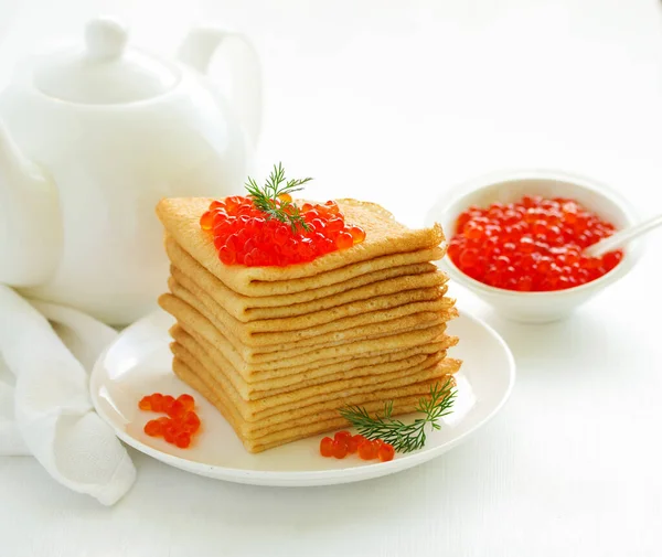 A pile of pancakes in Russian style with red caviar. .