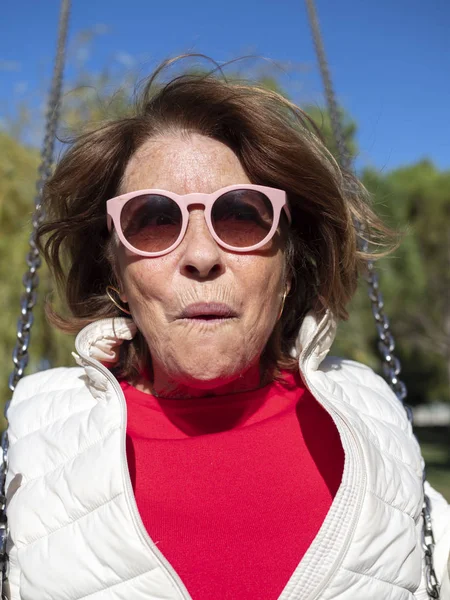 Cool older woman on a swing — Stock Photo, Image