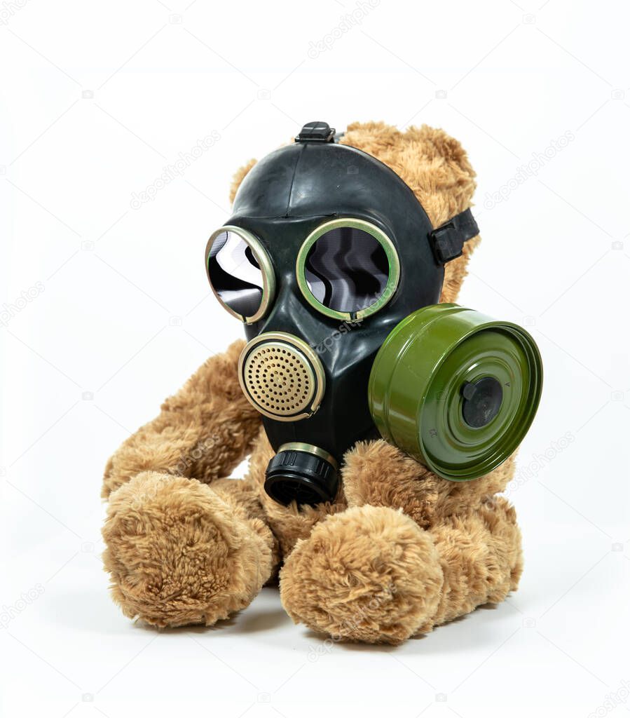 Toy bear wearing respirator mask with hypnotic spiral visuals in the eyes against white background.