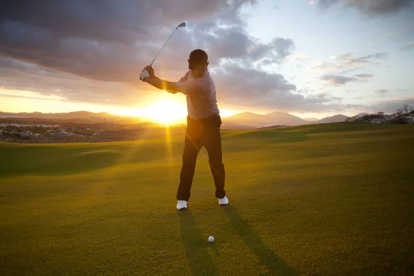 Man playing golf.