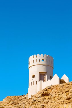 in oman muscat rock  the old defensive  fort battlesment sky and clipart