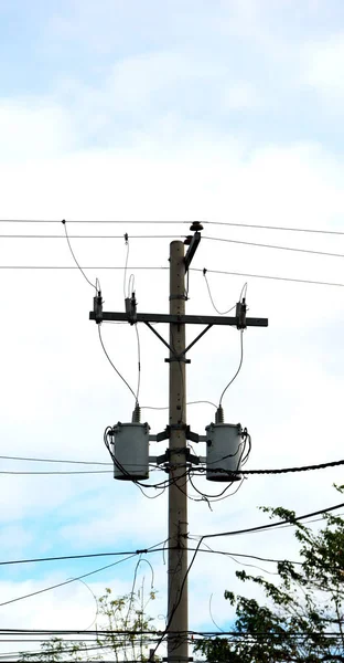 A electric pole with transformer and wire  the cloudy sky — Stock Photo, Image