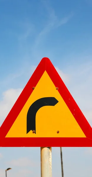 Road signal attention of the curve in the sky — Stock Photo, Image