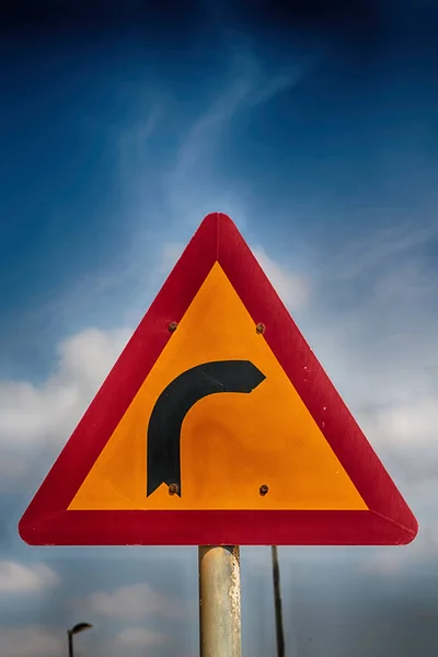 Road signal attention of the curve in the sky — Stock Photo, Image