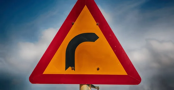 Road signal attention of the curve in the sky — Stock Photo, Image