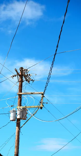 A electric pole with transformer and wire  the cloudy sky — Stock Photo, Image