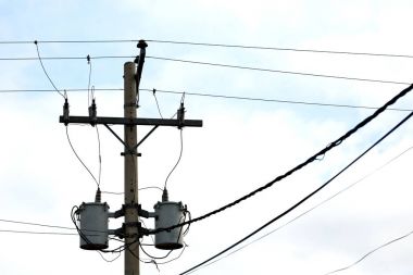 trafo ve tel bulutlu gökyüzü ile bir elektrik direği
