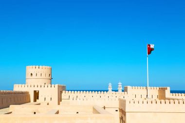 in oman    muscat    the   old defensive  fort battlesment sky a clipart