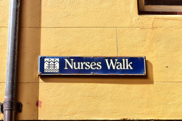 In the wall the sign of nursers walk  street — Stock Photo, Image