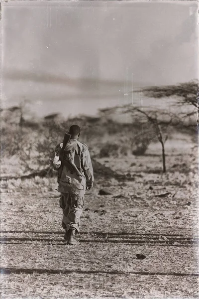 africa  in the land of ethiopia a black soldier  and his gun looking the boarder