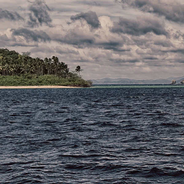 from a boat  in  philippines  snake island near el nido palawan beautiful panorama coastline sea and rock