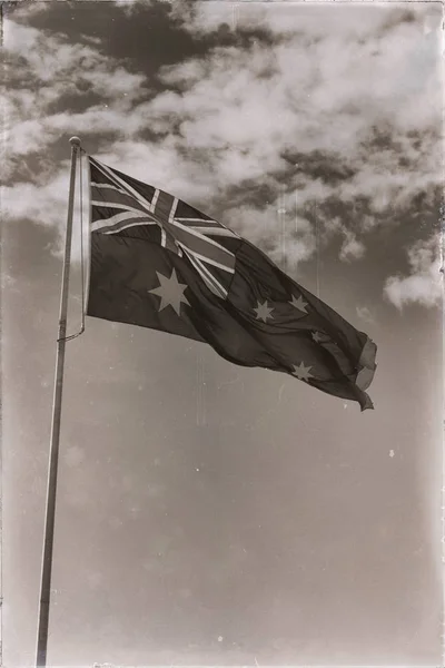 W bezchmurne niebo macha flagą — Zdjęcie stockowe
