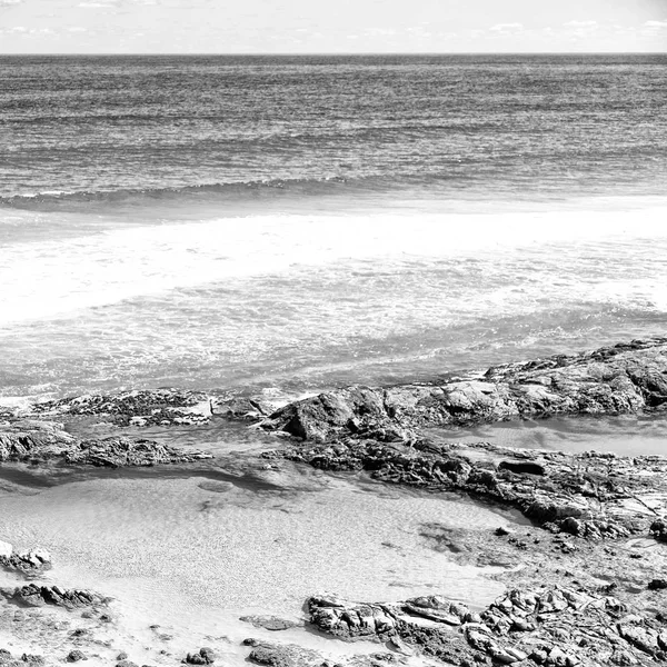 La playa cerca de las rocas en la ola del océano —  Fotos de Stock