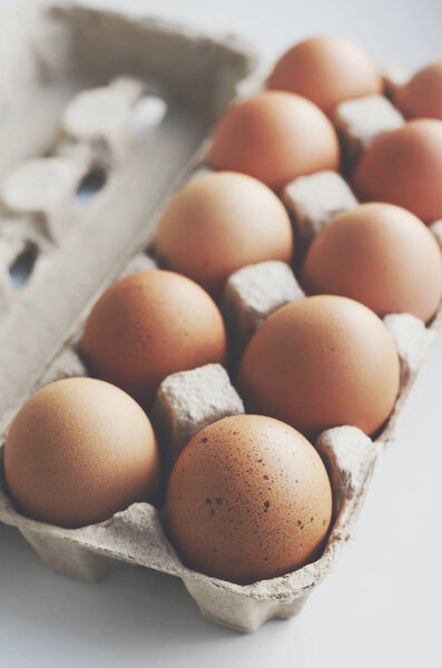 Brown eggs in cardboard box