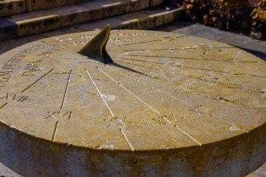 Old stone sundial with a shadow