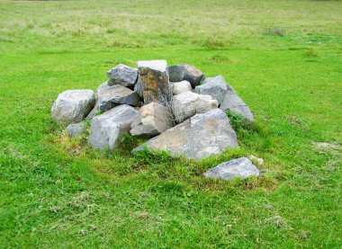 Yeşil çim ile bir çayırda taş yığını