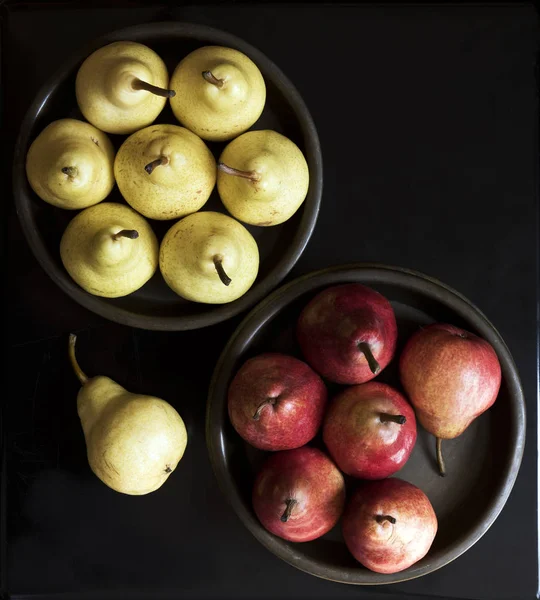 Yellow and red pears in bowls Stock Image