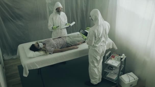 Two Scientist Attending Woman Virus Lying Stretcher Field Hospital — Stock Video