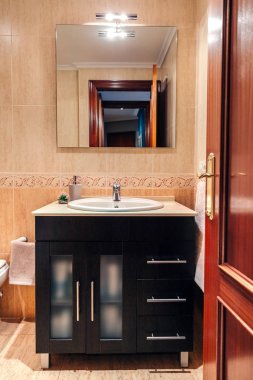 Lavabosu ve aynası olan banyo.