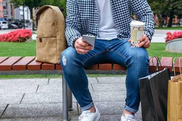 Man looking mobile sitting on a bench — Stock Photo, Image