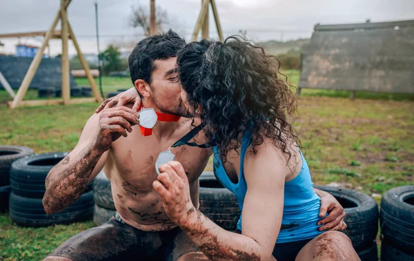 Спортсмены целуются и показывают медали — стоковое фото