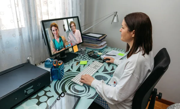 Женщина разговаривает на видео с матерью и врачом, давая медицинское заключение — стоковое фото