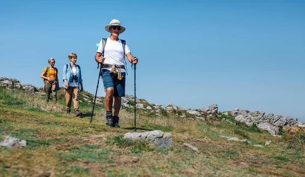 Three people practicing trekking outdoors — Stock Photo, Image