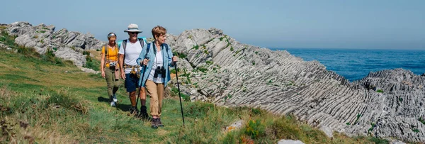 Three people practicing trekking outdoors — Stock Photo, Image