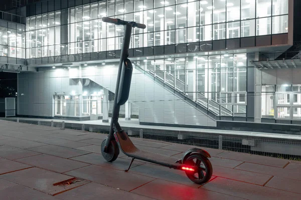 Electric scooter near metro railway station. urban cityscape. eco alternative transport concept. Back view. — Stock Photo, Image