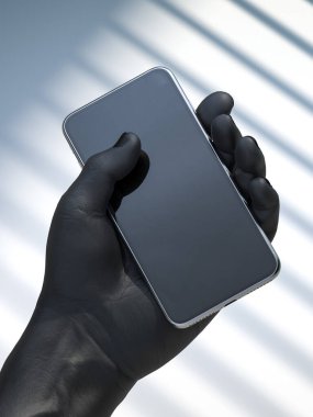 Realistic black human hand holding mobile phone with blank screen with empty space on light background. 3d rendering clipart
