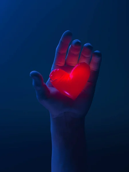 Lidská ruka drží červené zářící srdce. Návrh. Překvapení. Dávat lásku a náklonnost milované. 3D vykreslování. — Stock fotografie