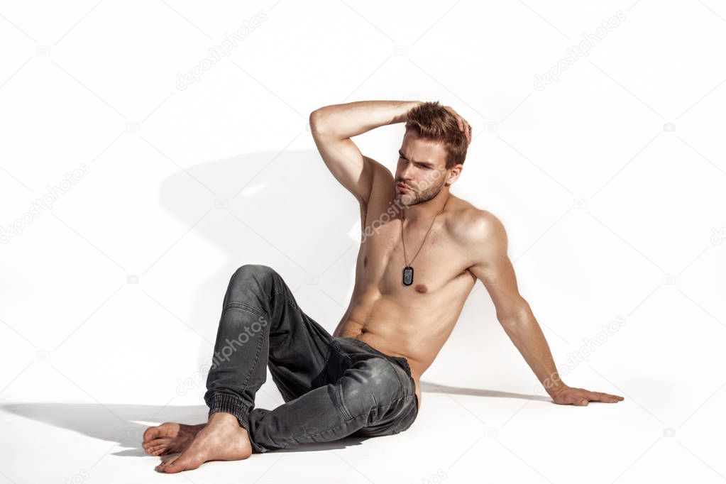 Muscle strong beautiful stripped male model in denim jeans on white isolated font background with shadow