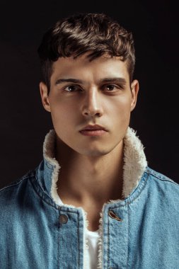 Kas gücü, beyaz kot pantolon ve kot ceketli siyah izole font arka planda beyaz tişörtlü güzel erkek manken.