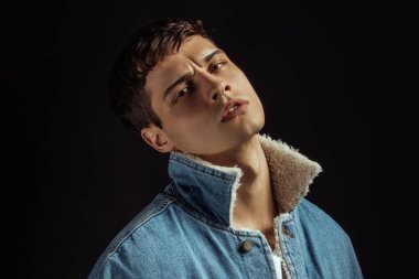 Kas gücü, beyaz kot pantolon ve kot ceketli siyah izole font arka planda beyaz tişörtlü güzel erkek manken.