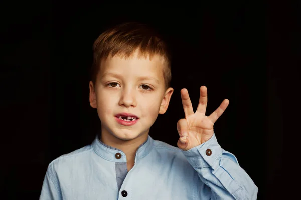 Lachende kindje, jongen hand tonen zijn eerste melk of tijdelijke tanden uitvallen. — Stockfoto