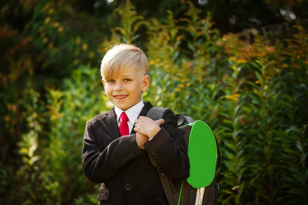 Cute boy going back to school. Boy in the suit. Closeup portrait of smiling pupil with backpack — Stock Photo, Image