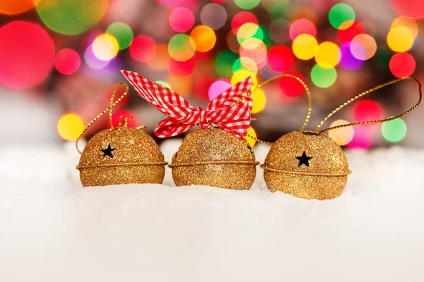 Greeting Christmas Card with Gold Jingle Bells on Colorful Bokeh Background. — Stock Photo, Image
