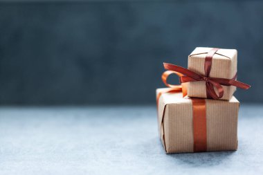 Tatiller koyu arkaplanda kahverengi kurdeleli kutular sunar