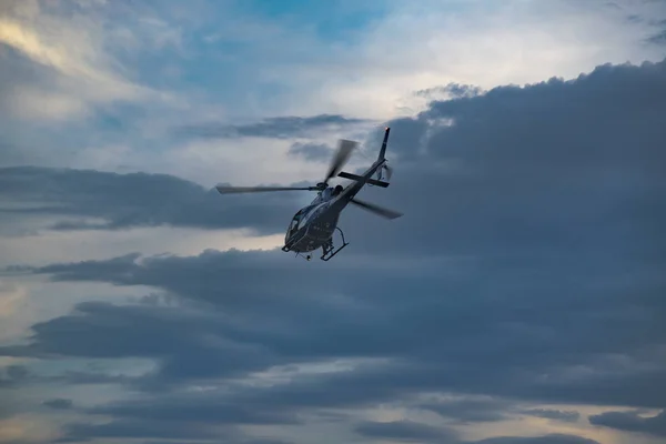 Helicóptero voando na hora do pôr do sol — Fotografia de Stock