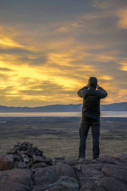 Man Taking Photos at Sunset. Patagonia, Argentina clipart