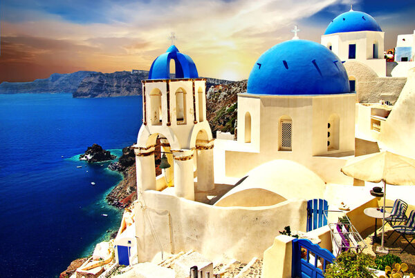 Amazing Santorini over sunrise. View of Oia village with famous church,Greece.